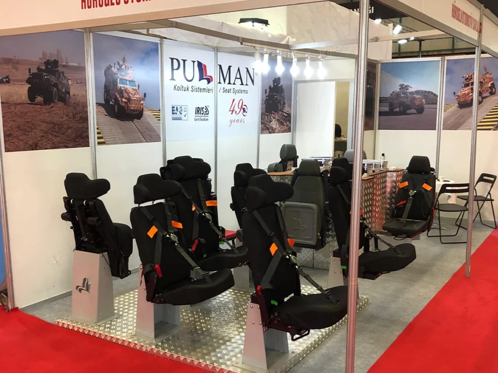 Military vehicle seats with harnesses displayed at the Pullman Seats stand at IDEF 2021
